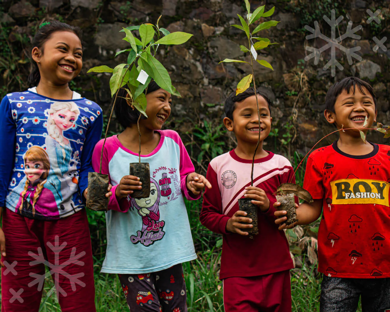 Children holding young tree saplings  part of JGO and OneTreePlanted reforestation initiative